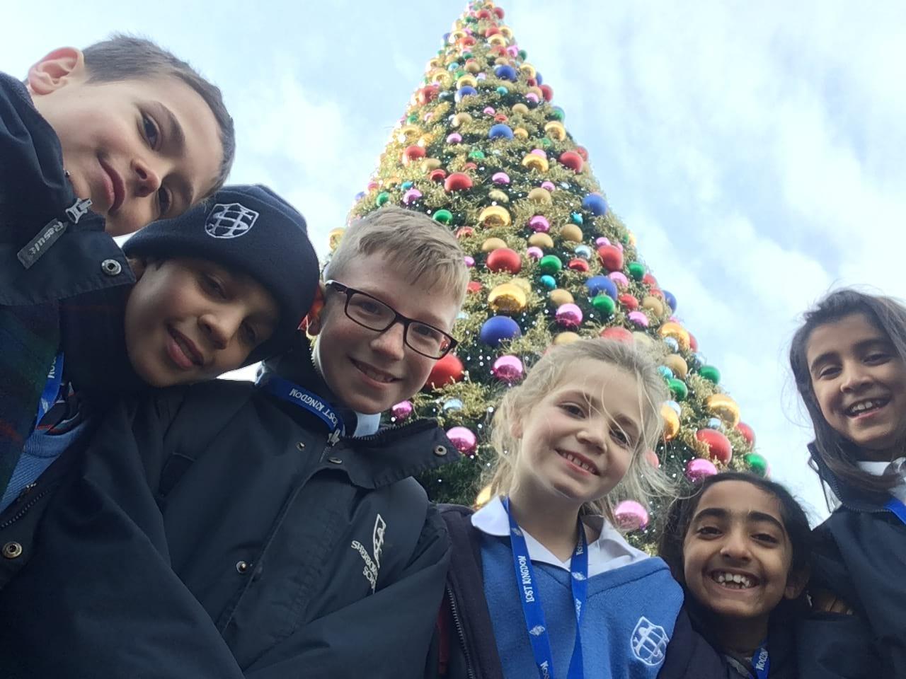 school group next to Christmas tree